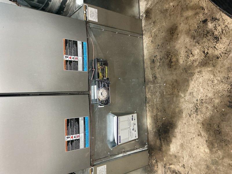 Arrived on-site during scheduled window for inspection of recently completed commercial HVAC installation. Documented two large-capacity air handling units with associated ductwork, electrical connections, and control components in warehouse mechanical space. Installation inspection confirmed proper equipment placement, secure duct connections, appropriate electrical terminations, and compliance with commercial building codes for final approval.