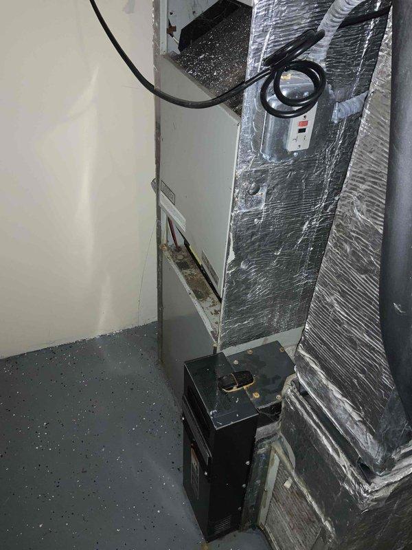 Completed HVAC estimate for air conditioning system replacement in basement location. Existing 10+ year old AC unit is non-operational while furnace remains functional. Assessed current air handler installation with reflective foil-wrapped ductwork, condensate pump, and refrigerant line routing through mechanical space with exposed ceiling joists and existing ventilation infrastructure.