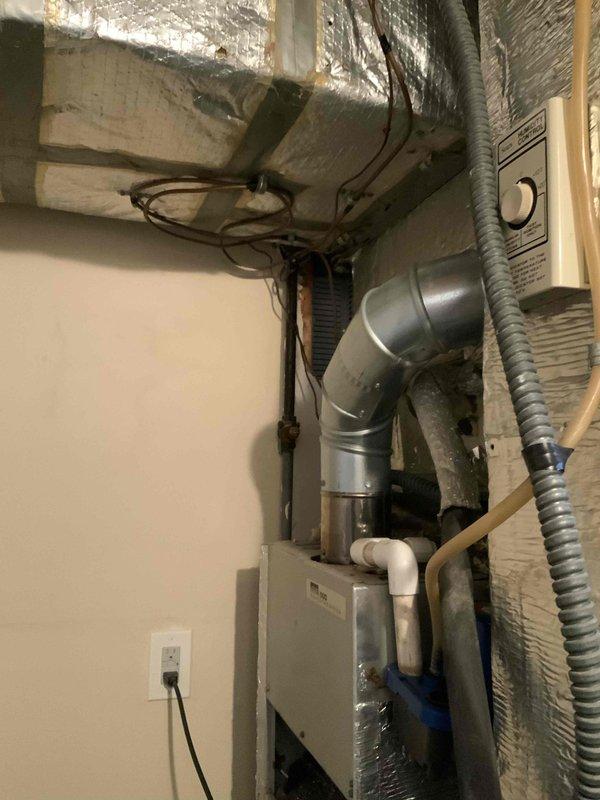 Completed HVAC estimate for air conditioning system replacement in basement location. Existing 10+ year old AC unit is non-operational while furnace remains functional. Assessed current air handler installation with reflective foil-wrapped ductwork, condensate pump, and refrigerant line routing through mechanical space with exposed ceiling joists and existing ventilation infrastructure.