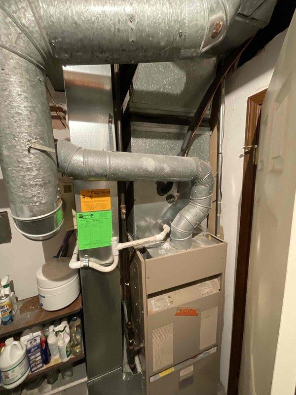 Completed estimate for replacement of 39-year-old York furnace and air conditioning system located in basement mechanical room. Assessed existing natural gas furnace with associated ductwork and outdoor condensing unit, both units operational but at end of service life. Provided BOGO replacement quote for complete heating and cooling system upgrade including new furnace, air handler, evaporator coil, and outdoor condensing unit with updated refrigerant lines and necessary electrical connections.