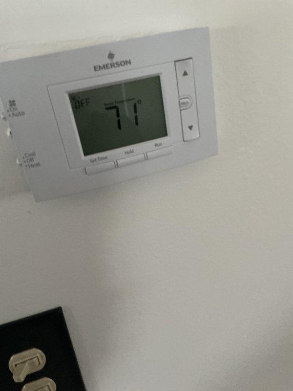 Completed comprehensive HVAC maintenance inspection including both heating and cooling systems. Performed electrical diagnostics with multimeter, verifying proper voltage readings at 5.49V on control circuits, and inspected internal components including blower assembly, wiring connections, and control boards. Confirmed thermostat operation showing 77°F with system in OFF mode and all programming functions working correctly.