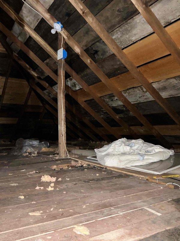 Conducted comprehensive site assessment for complete HVAC system installation in small cottage with no existing heating or cooling infrastructure. Performed detailed attic inspection to evaluate structural conditions, available space constraints, and installation feasibility for new furnace and air conditioning system. Documented existing attic conditions including exposed rafter system, aged wooden decking with moisture staining, displaced fiberglass insulation, and current electrical utility placement. Assessed structural capacity, insulation requirements, and optimal equipment placement options for ductwork routing and system installation. Provided full system estimate covering heating and cooling equipment installation to bring property up to modern comfort standards.