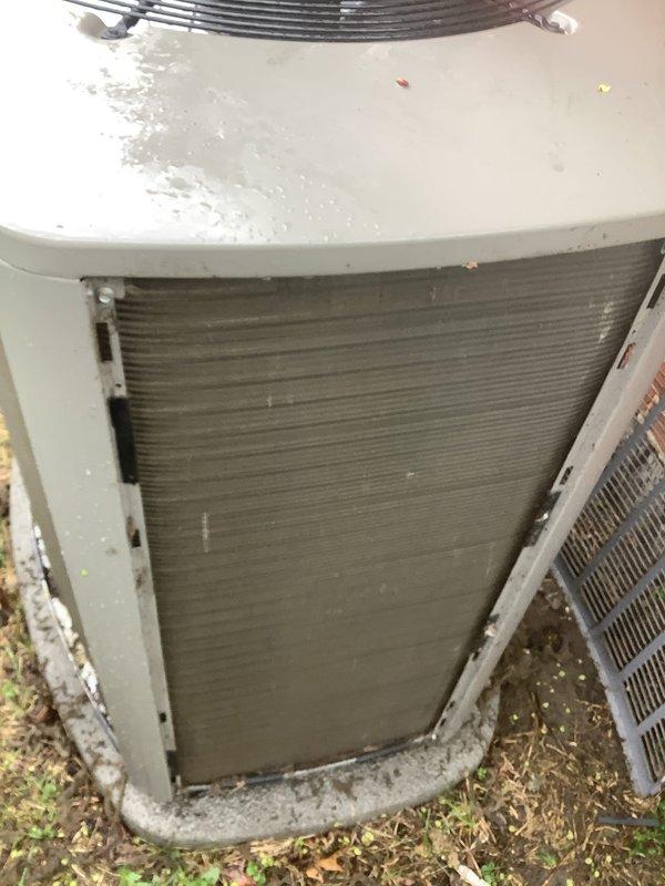 Completed routine Air Care Maintenance on residential air conditioning system. Performed comprehensive inspection of outdoor condenser unit, noting significant dirt and debris accumulation on coil fins requiring attention. Unit exterior showed normal weathering with moisture present from recent precipitation. Documented equipment condition through photographic records showing coil contamination and overall system status. All standard ACM procedures executed per protocol with unit operational at time of service completion.