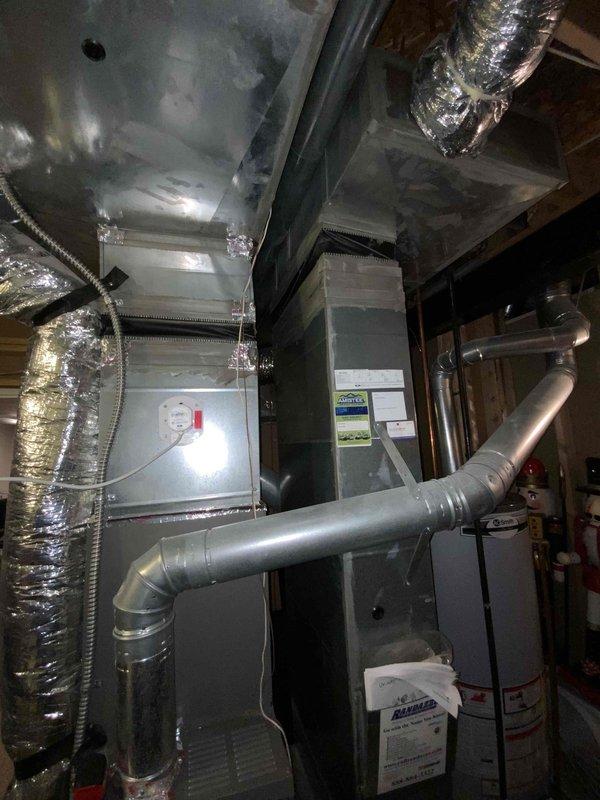 Provided comprehensive estimate for full HVAC system replacement in mid-large residential property (2000-3000 sq.ft.) with basement installation. Assessed existing heating and cooling infrastructure including air handler unit, ductwork configuration, and natural gas/propane compatibility for combined heating and cooling system. Documented current equipment layout, utility room dimensions, and existing duct routing to develop specifications for new system installation.
