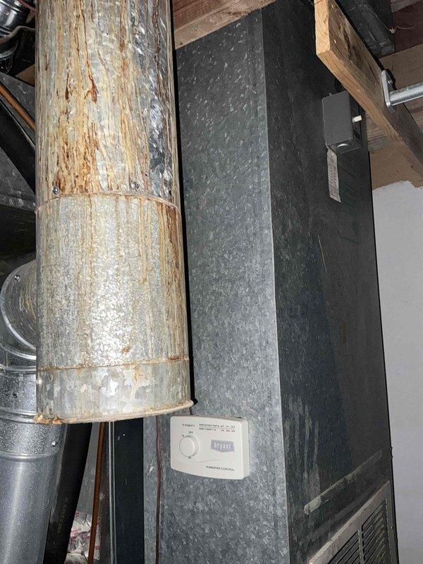 Conducted comprehensive assessment of existing HVAC system for replacement estimate. Evaluated 18-year-old furnace and 16-year-old air conditioning unit showing significant age-related deterioration. Documented current equipment condition including corroded ductwork, aged insulation wrapping, and weathered mechanical components in basement utility area. Photographed furnace with connected PVC condensate drainage lines, copper piping, and deteriorated reflective duct insulation. Assessed AC system components and overall infrastructure to provide accurate replacement recommendations. Prepared detailed estimate for complete HVAC system replacement to address equipment exceeding expected service life.