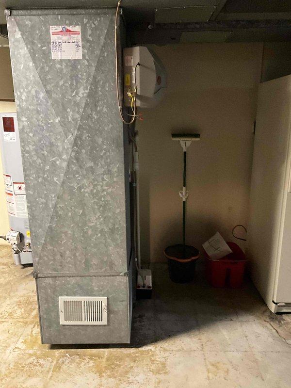 Provided estimate for replacement of 20-year-old Goodman furnace located in basement utility area. Current unit is operational but has reached end of expected service life. Assessed existing installation including ductwork connections, gas line configuration, electrical service, and clearances in mechanical room shared with water heater.