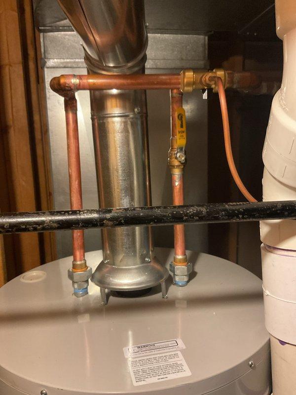 Completed full HVAC system installation including 4-ton air conditioning unit with evaporator coil and hot water heater replacement. Unit positioned at rear of property with electrical reconnection performed by licensed electrician. All copper refrigerant lines installed and brazed with proper insulation, gas piping connected to new water heater with code-compliant yellow-handle shutoff valve, and flue venting properly secured to existing ductwork. Mechanical and electrical permits obtained prior to installation. System tested and verified operational upon completion.