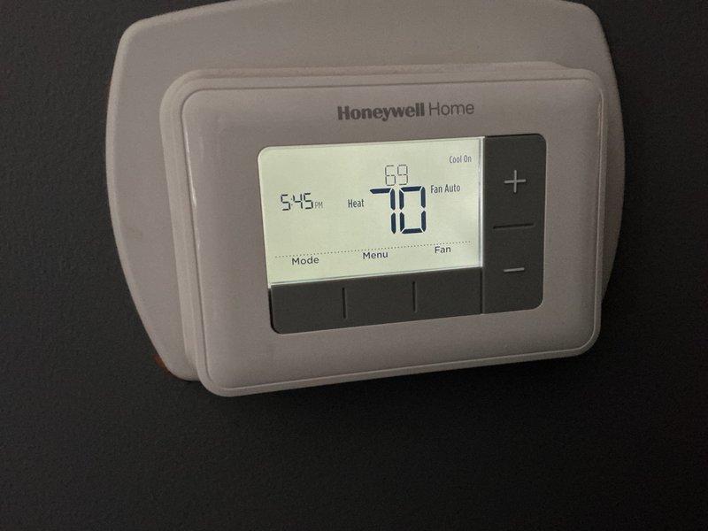 Completed annual furnace maintenance and tune-up on a new heating system under membership agreement. Performed comprehensive system inspection, verified electrical current draw using clamp meter, and confirmed proper thermostat operation with Honeywell Home digital control displaying accurate temperature readings and system status. All components operating within manufacturer specifications with no issues found.