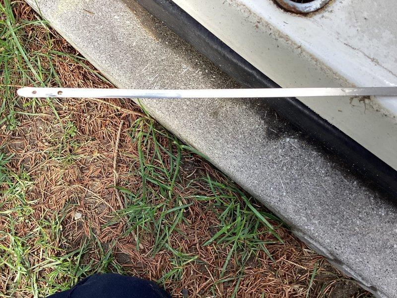 Responded to service call for 10+ year old Generac 16KW standby generator reported to be smoking and leaking oil. Upon arrival, performed comprehensive diagnostic inspection of unit. Visual examination revealed significant oil leakage from engine block area with substantial oil residue accumulated on concrete pad beneath generator. Identified oil filter housing as primary source of leak, with evidence of oil streaming down engine components. Oil filter showed signs of improper sealing or gasket failure, causing pressurized oil to escape during operation. The smoking condition was determined to be oil vapor and smoke from leaked oil contacting hot engine surfaces during runtime. Inspected engine block, oil pan, and all external oil lines for additional leak sources. Documented equipment condition with photographic evidence showing oil staining patterns on generator base and mounting platform. Noted water streaking on external components indicating potential exposure to weather elements 