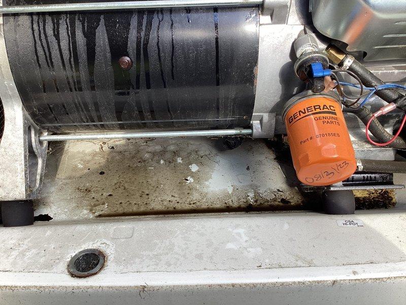 Responded to service call for 10+ year old Generac 16KW standby generator reported to be smoking and leaking oil. Upon arrival, performed comprehensive diagnostic inspection of unit. Visual examination revealed significant oil leakage from engine block area with substantial oil residue accumulated on concrete pad beneath generator. Identified oil filter housing as primary source of leak, with evidence of oil streaming down engine components. Oil filter showed signs of improper sealing or gasket failure, causing pressurized oil to escape during operation. The smoking condition was determined to be oil vapor and smoke from leaked oil contacting hot engine surfaces during runtime. Inspected engine block, oil pan, and all external oil lines for additional leak sources. Documented equipment condition with photographic evidence showing oil staining patterns on generator base and mounting platform. Noted water streaking on external components indicating potential exposure to weather elements 