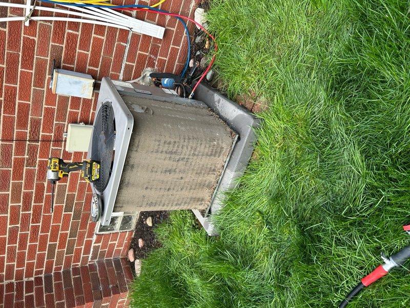 Completed comprehensive preventive maintenance on a 9-year-old residential central air conditioning system. Performed full system inspection of outdoor condenser unit and air handler, checking all electrical connections, refrigerant lines, and service ports. Cleaned condenser coils and exterior surfaces, removing accumulated dirt and debris from outdoor unit. Verified proper operation of condenser fan motor and compressor. Inspected refrigerant line insulation and service port caps for integrity. Checked electrical wiring connections at unit and wall-mounted disconnect. Confirmed system operating within normal parameters with no issues detected. Unit functioning properly upon completion of routine maintenance service.