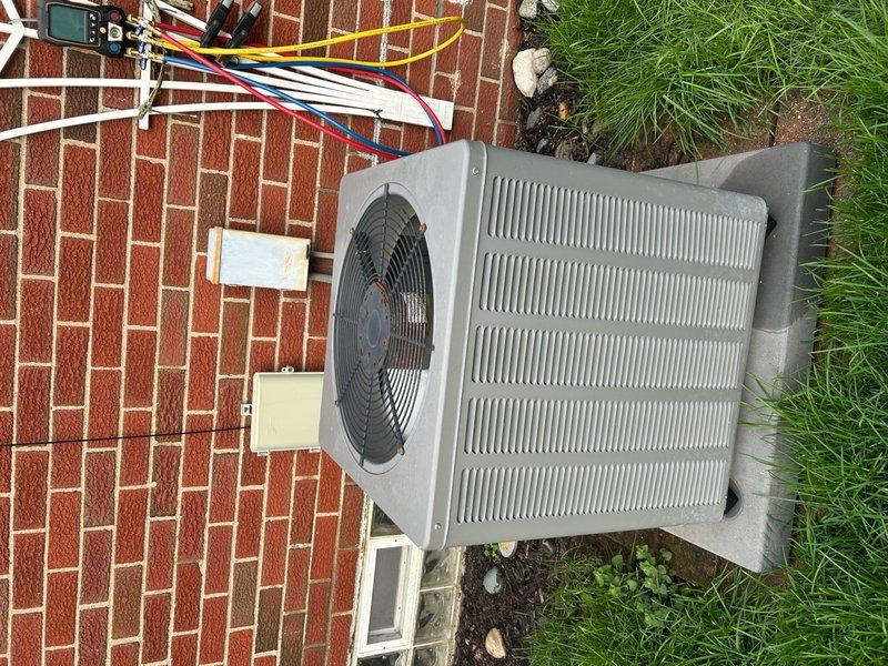 Completed comprehensive preventive maintenance on a 9-year-old residential central air conditioning system. Performed full system inspection of outdoor condenser unit and air handler, checking all electrical connections, refrigerant lines, and service ports. Cleaned condenser coils and exterior surfaces, removing accumulated dirt and debris from outdoor unit. Verified proper operation of condenser fan motor and compressor. Inspected refrigerant line insulation and service port caps for integrity. Checked electrical wiring connections at unit and wall-mounted disconnect. Confirmed system operating within normal parameters with no issues detected. Unit functioning properly upon completion of routine maintenance service.