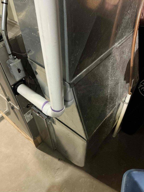 Conducted comprehensive assessment of existing 16-year-old air conditioning system that ceased operation during previous cooling season. Evaluated both indoor air handler unit located in basement mechanical room and outdoor condensing unit positioned against exterior wall with mulch bedding. Inspected electrical connections, condensate drainage system with PVC piping, and overall equipment condition. Documented current installation configuration including existing furnace that was replaced 13 years prior, while original AC system remained in service until failure. Provided full system replacement estimate for new HVAC equipment to address failed air conditioning unit and ensure proper system matching with existing infrastructure. Photographed existing equipment placement, electrical conduit routing, drainage lines, and installation environment for replacement planning purposes.