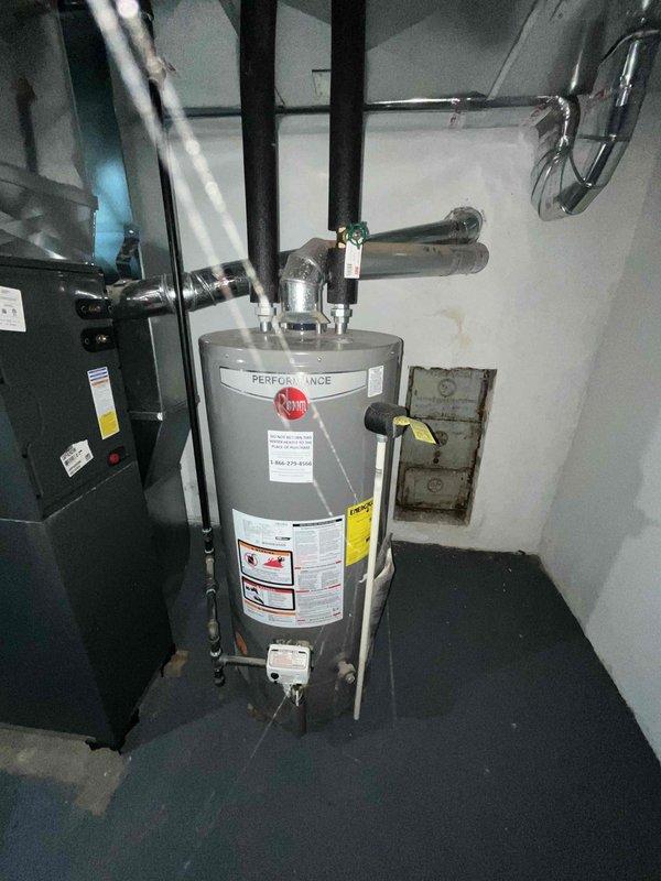 Conducted comprehensive site assessment for new central air conditioning system installation at residence with no existing A/C equipment. Evaluated basement mechanical room containing existing gas furnace and water heater to determine optimal placement and integration requirements for new cooling system. Documented current HVAC infrastructure including furnace unit with overhead ductwork, examining existing supply and return air distribution system for compatibility with air conditioning addition. Assessed electrical service capacity and available space for outdoor condensing unit placement. Reviewed gas piping, water heater configuration, and utility clearances to ensure proper code compliance for new equipment installation. Photographed existing mechanical equipment, ductwork connections, and available installation space to prepare accurate material list and labor estimate. Measured basement ceiling height, duct dimensions, and equipment clearances to determine appropriate tonnage re