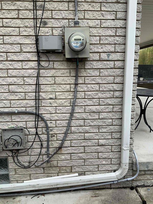 Conducted comprehensive site assessment for whole house Kohler generator installation at 60-year-old residence. Evaluated existing electrical service including meter location, panel capacity, and electrical routing pathways. Documented current electrical infrastructure with weatherproof meter enclosure, junction boxes, and conduit configuration on exterior brick wall. Assessed generator placement options considering required clearances per manufacturer specifications including 10-foot, 5-foot, and 24-inch minimum distances from structures and utilities. Reviewed unit restrictions, orientation requirements (perpendicular/parallel configurations), and optimal positioning relative to existing electrical service entrance. Completed standardized placement checklist documenting panel configuration, breaker locations, meter grade to service drop, gas routing availability, and transfer switch installation pathway. Photographed all required components for estimate preparation including floor-to