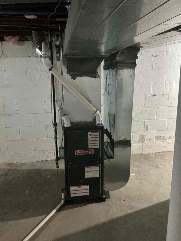 Conducted on-site evaluation for complete air conditioning system replacement at residential property. Assessed existing HVAC infrastructure including Goodman furnace unit, ductwork distribution system, and electrical panel capacity in basement mechanical room. Documented current equipment configuration, PVC venting arrangement, sheet metal ductwork connections, and electrical service panel to determine specifications and requirements for new AC system installation.