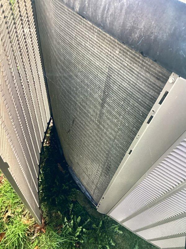 Completed annual cooling maintenance on residential outdoor condensing unit. Performed comprehensive inspection of heat exchanger coils, noting moderate accumulation of organic growth and debris on condenser fins. Cleaned coil surfaces to restore proper airflow and heat transfer efficiency. Inspected exterior cabinet panels and louvers for structural integrity and proper ventilation clearance. Verified unit placement and surrounding vegetation management. All system components assessed and operational parameters confirmed within manufacturer specifications following maintenance procedures.