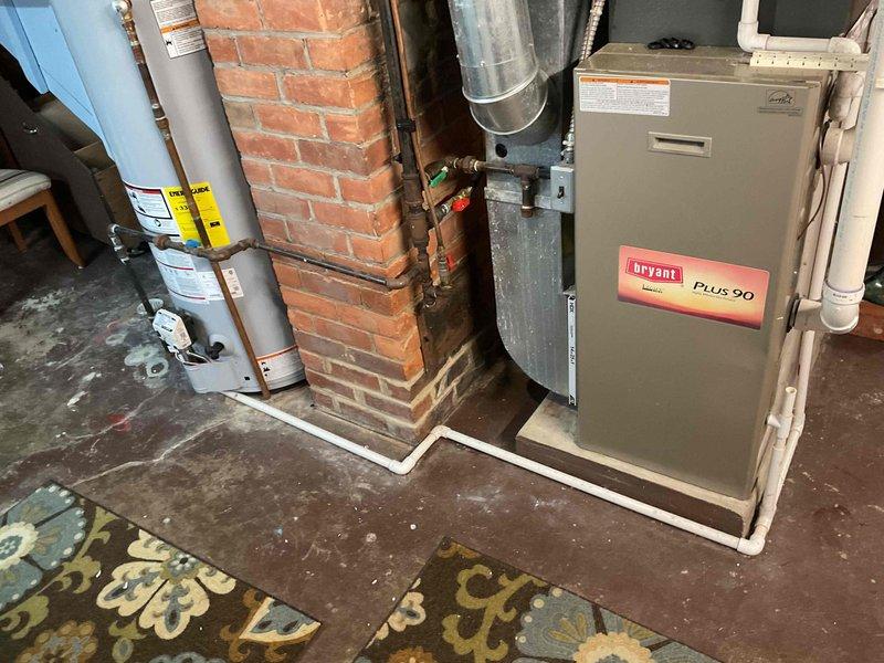 Completed estimate for furnace replacement in residential basement mechanical room. Documented existing Bryant Plus 90 high-efficiency furnace, associated ductwork, venting system, and surrounding utility infrastructure including water heater and electrical panel to provide accurate replacement specifications and equipment requirements.