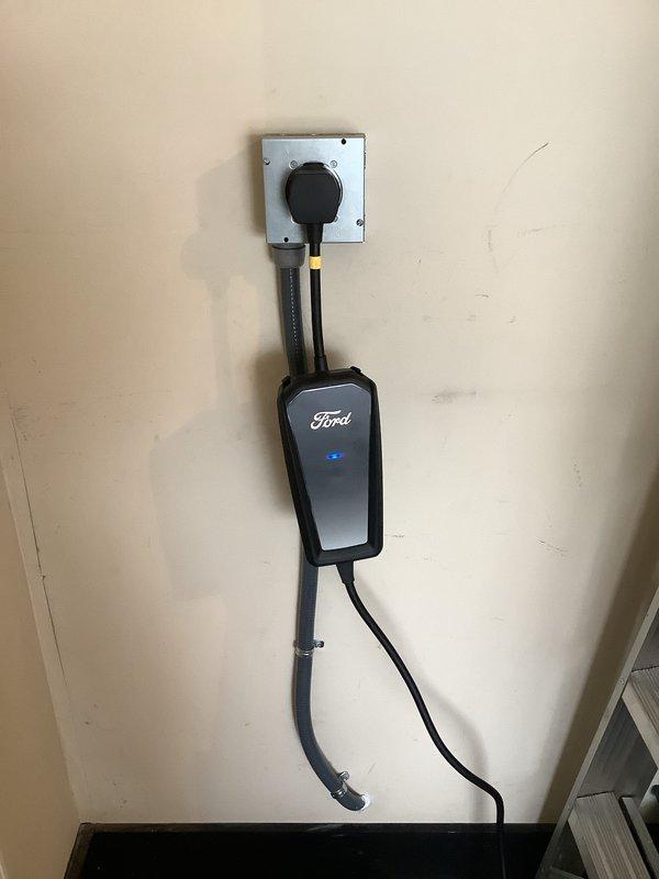 Successfully installed a Ford-branded Level 2 electric vehicle charging station with a new dedicated circuit. Ran electrical conduit from the main service panel through the attic space to the garage mounting location, installed a specialized high-voltage receptacle, and mounted the EV charger unit on the garage wall. All work completed in accordance with electrical code requirements and permit specifications, with the charging station tested and operational upon completion.