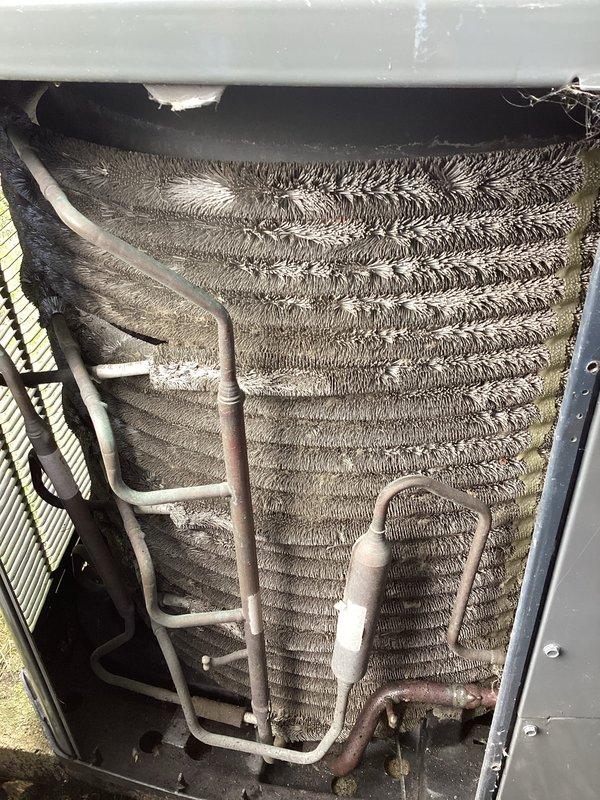 Performed annual cleaning and maintenance on HVAC system per customer request. Upon inspection, found both evaporator coil and condenser unit heavily contaminated with accumulated dust, dirt, and debris. The evaporator coil exhibited severely matted and compressed aluminum fins with significant buildup causing grayish-brown discoloration throughout. Fin spacing was compromised due to dense accumulation creating a felted texture across surfaces. Condenser unit showed similar heavy contamination with thick, matted debris layer obscuring individual fin spacing and restricting airflow.

Thoroughly cleaned evaporator coil assembly, removing accumulated contaminants from aluminum fins and restoring proper fin spacing for optimal heat transfer. Cleaned copper refrigerant tubing showing oxidation and discoloration. Addressed condenser coil cleaning, removing substantial debris buildup from all accessible fin surfaces to restore airflow capacity and heat exchange efficiency. Inspected refrigera