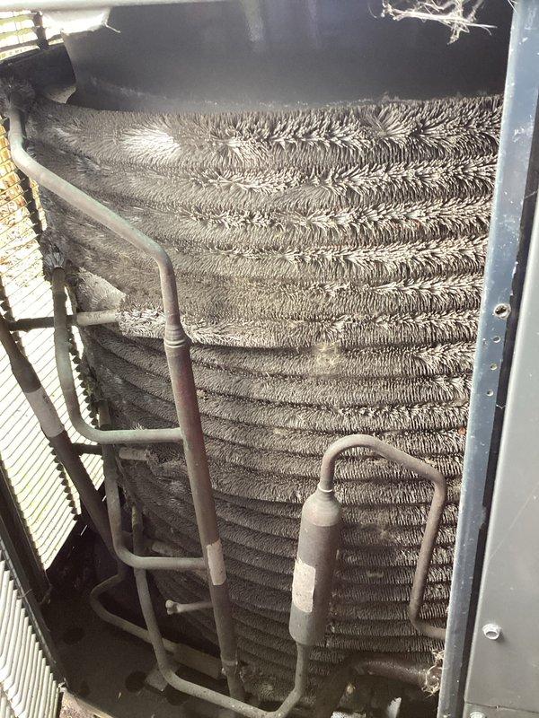Performed annual cleaning and maintenance on HVAC system per customer request. Upon inspection, found both evaporator coil and condenser unit heavily contaminated with accumulated dust, dirt, and debris. The evaporator coil exhibited severely matted and compressed aluminum fins with significant buildup causing grayish-brown discoloration throughout. Fin spacing was compromised due to dense accumulation creating a felted texture across surfaces. Condenser unit showed similar heavy contamination with thick, matted debris layer obscuring individual fin spacing and restricting airflow.

Thoroughly cleaned evaporator coil assembly, removing accumulated contaminants from aluminum fins and restoring proper fin spacing for optimal heat transfer. Cleaned copper refrigerant tubing showing oxidation and discoloration. Addressed condenser coil cleaning, removing substantial debris buildup from all accessible fin surfaces to restore airflow capacity and heat exchange efficiency. Inspected refrigera