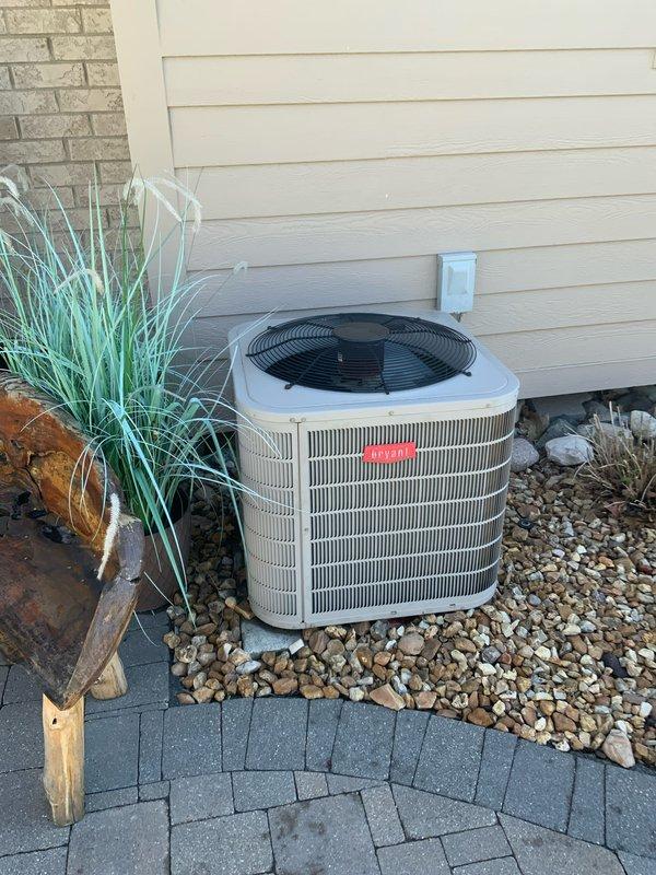 Conducted on-site assessment for complete HVAC system replacement estimate at residential property. Evaluated existing 20-year-old air conditioning unit utilizing R-410A refrigerant and 14-year-old furnace, both systems having reached end of serviceable life expectancy. Documented current equipment condition, installation configuration, and site specifications through comprehensive photography of outdoor condenser unit positioning, electrical disconnect location, and surrounding landscape considerations for replacement planning.