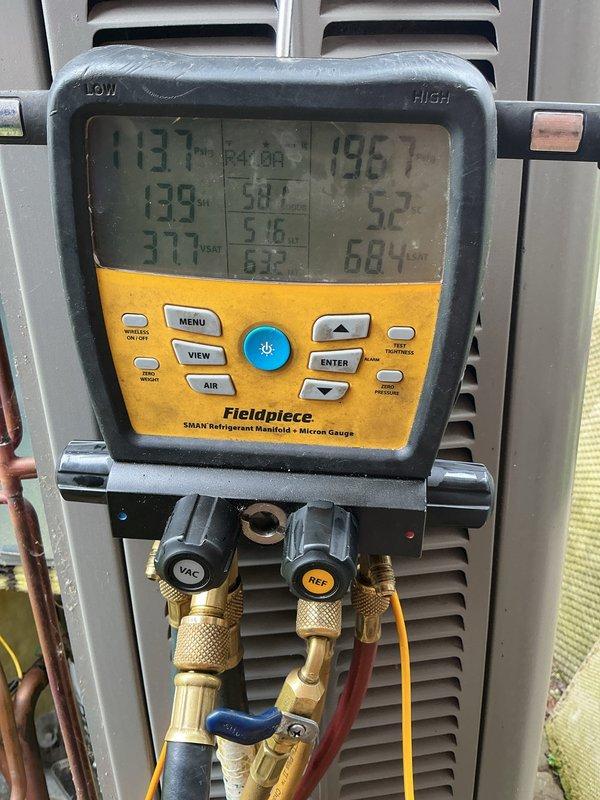 Completed annual cooling maintenance on residential air conditioning system. Performed comprehensive system inspection including refrigerant line assessment, noting weathered insulation on copper lines requiring future attention. Utilized Fieldpiece SMAN refrigerant manifold and micron gauge to verify system pressures and refrigerant charge levels, confirming all readings within manufacturer specifications for optimal cooling performance.