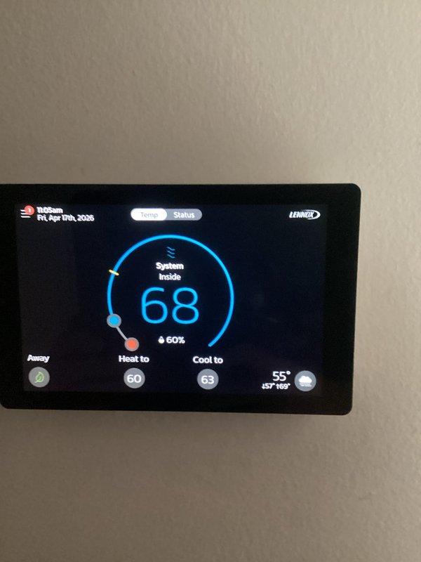 Completed routine air conditioning maintenance service on residential cooling system. Performed system diagnostics using refrigerant manifold gauge, recording operating pressures and temperatures to verify proper refrigerant charge and system performance. Confirmed thermostat operation and settings, with unit maintaining 68°F setpoint at 60% indoor humidity with heat set to 60°F and cooling set to 63°F. All system parameters found within normal operating range with no deficiencies noted.