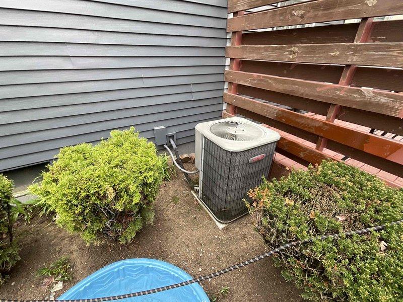 Conducted comprehensive assessment of 20-year-old residential HVAC system for replacement estimate, including natural gas furnace located in basement utility area and Bryant air conditioning condenser unit positioned in exterior side yard. Furnace currently operational while air conditioning unit non-functional. Documented existing equipment configuration, ductwork connections, electrical systems, clearances, and installation access points for complete system replacement proposal.