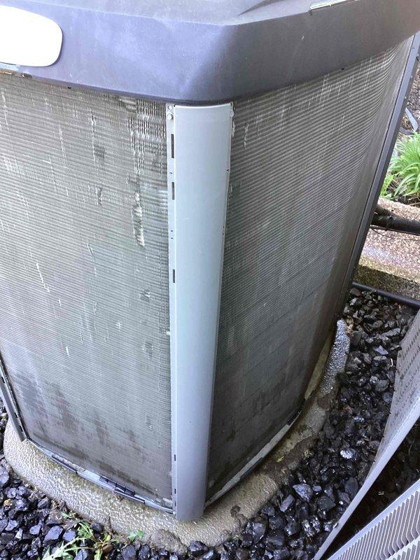 Completed annual cooling maintenance on residential air conditioning condenser unit. Performed system inspection, replaced air filter and evaporator pad as part of scheduled preventative maintenance program. Unit exterior shows significant weathering and coating deterioration on panels, though system remains operational. Documentation photos captured for service records and future reference regarding cabinet condition.