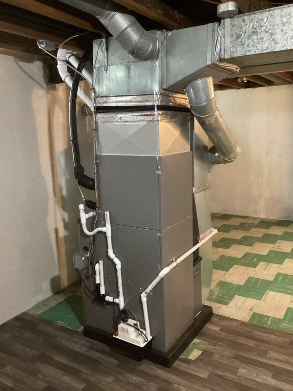 Completed full HVAC system installation including a 70,000 BTU furnace and 2-ton air conditioning unit with rear discharge configuration in residential basement. Installed all necessary ductwork connections, PVC venting and drainage piping, condensate pump, gas line reconnection, and electrical connections per mechanical and electrical permits. System tested and operational upon completion.