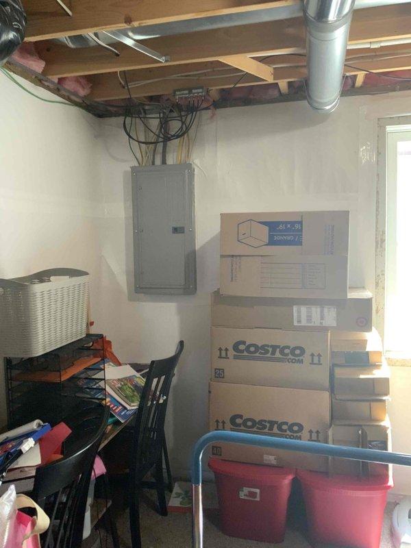 Conducted on-site evaluation for new standby generator installation. Assessed existing electrical infrastructure including main service panel with dual-column breaker configuration and available capacity for generator integration. Documented current electrical distribution system in unfinished basement utility area and photographed panel layout to determine optimal connection point and transfer switch requirements for proposed automatic standby generator system.