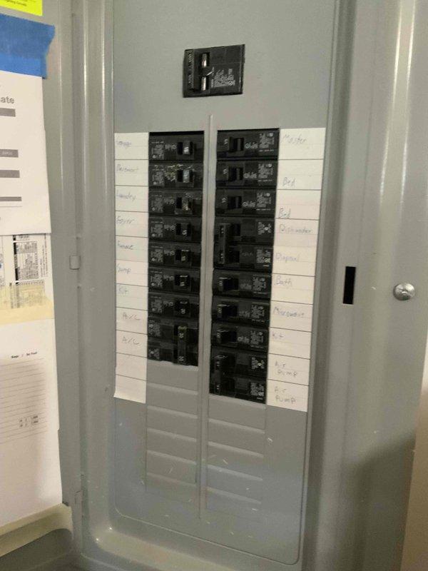 Conducted on-site evaluation for new standby generator installation. Assessed existing electrical infrastructure including main service panel with dual-column breaker configuration and available capacity for generator integration. Documented current electrical distribution system in unfinished basement utility area and photographed panel layout to determine optimal connection point and transfer switch requirements for proposed automatic standby generator system.