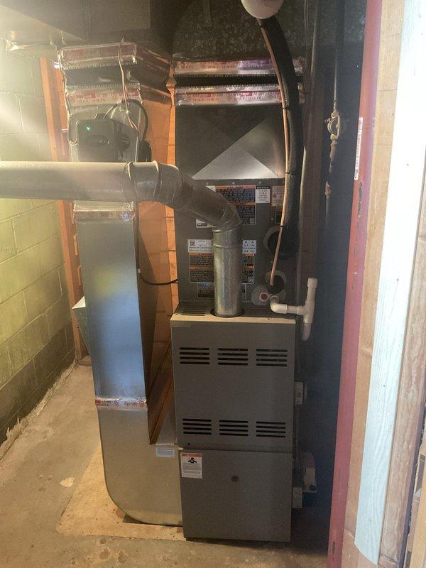 Completed installation of 2-ton air conditioning system with evaporator coil in basement mechanical room. Installed new copper evaporator coil assembly above existing furnace unit with proper ductwork transitions and connections. Connected outdoor condenser unit to indoor coil assembly, completed all refrigerant line connections, established electrical reconnection, and verified system operation. Mechanical and electrical permits obtained prior to installation.
