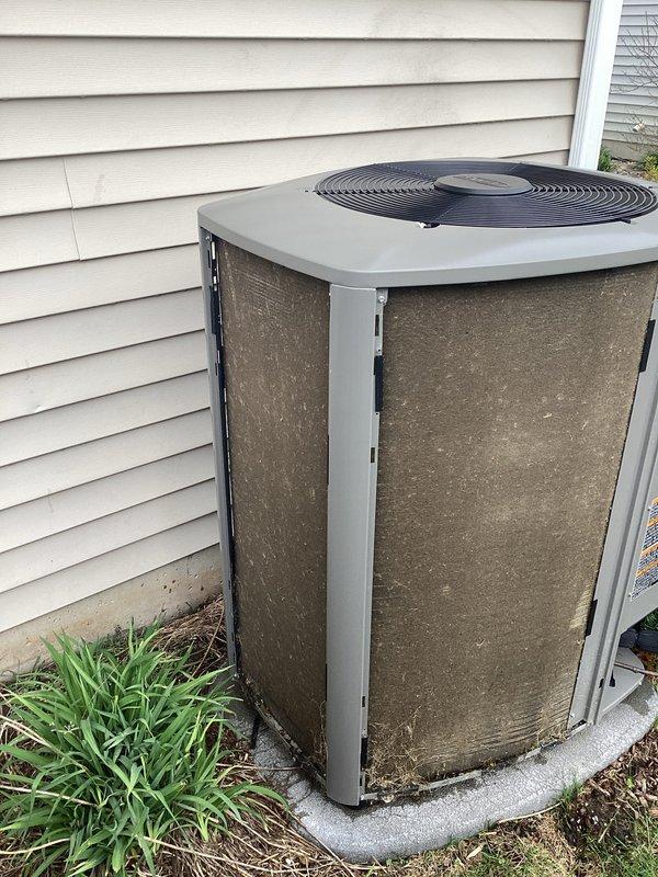 Completed scheduled preventative maintenance on residential air conditioning system. Inspected outdoor condenser unit, noting significant dirt and debris accumulation on exterior panels requiring cleaning attention. Examined indoor evaporator coil assembly, drain pan, condensate drain lines with PVC trap assembly, and flexible coupling connections. Replaced air filter and evaporator pad as part of routine maintenance protocol to ensure optimal system performance and efficiency.