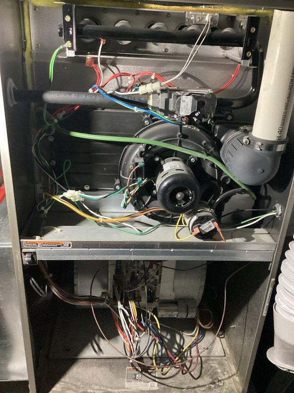 Completed annual heating maintenance on residential gas furnace system. Performed comprehensive inspection of blower motor assembly, heat exchanger, gas valve, electrical connections, and control components. All wiring connections verified secure with proper color-coded routing throughout upper and lower compartments. Blower motor operating within normal parameters. Heat exchanger inspected with no visible cracks or damage. Gas valve and burner assembly checked for proper operation. Unit tested and confirmed functioning correctly for continued reliable heating operation.