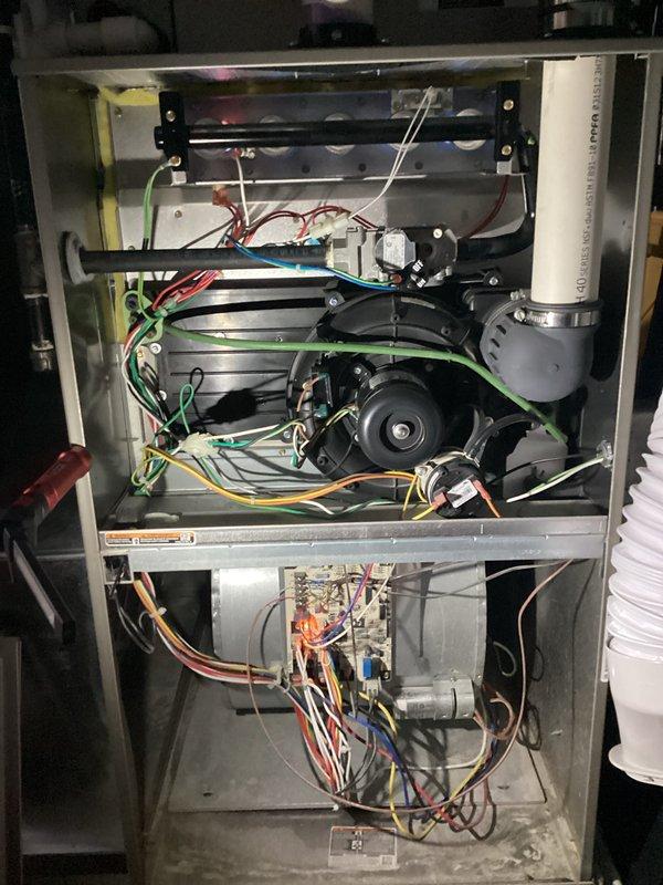Completed annual heating maintenance on residential gas furnace system. Performed comprehensive inspection of blower motor assembly, heat exchanger, gas valve, electrical connections, and control components. All wiring connections verified secure with proper color-coded routing throughout upper and lower compartments. Blower motor operating within normal parameters. Heat exchanger inspected with no visible cracks or damage. Gas valve and burner assembly checked for proper operation. Unit tested and confirmed functioning correctly for continued reliable heating operation.