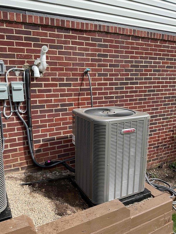 Completed dual-zone HVAC system installation consisting of two complete furnace and air conditioning combinations. Installed first system with 70,000 BTU Lennox furnace and 2.5-ton AC condenser unit positioned on right side of property, and second system with 90,000 BTU Lennox furnace and 3.5-ton AC condenser unit, also right-side mounted. Interior installation included proper venting configuration with white PVC piping for exhaust and intake, black flexible condensate drainage lines, and complete electrical connections with dedicated circuits and disconnect switches. Exterior condenser units mounted on concrete pads with gravel base for drainage, refrigerant line sets installed with proper insulation, and electrical disconnects mounted to building exterior. All mechanical, electrical, and plumbing permits obtained and work performed to code. Systems tested, operational, and ready for service.