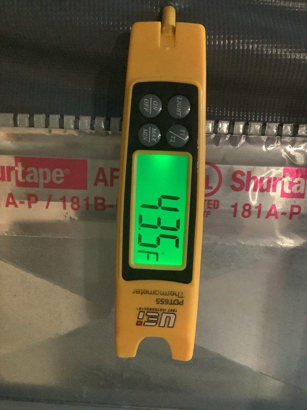 Completed scheduled ACM preventive maintenance on residential air conditioning system. Performed system diagnostics and recorded supply air temperature of 45.7°F using calibrated digital thermometer. Inspected outdoor condensing unit and identified heavily soiled air filter with significant accumulation of dirt, debris, and organic matter restricting airflow. Documented filter condition showing grayish-brown discoloration and streaked contamination patterns across surface. Unit operational with leaves and yard debris present around base requiring attention for proper system performance.
