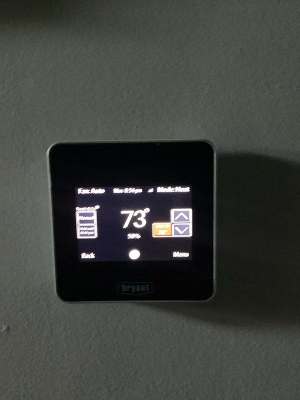 Completed annual furnace maintenance tune-up on brand new heating system per membership agreement. Performed comprehensive inspection of all internal components including blower motor assembly, gas valve connections, electrical wiring, control board, and thermostat operation. Verified proper furnace operation with Bryant thermostat displaying 73° setpoint in heating mode with fan set to auto. System operating within normal parameters with no issues found.