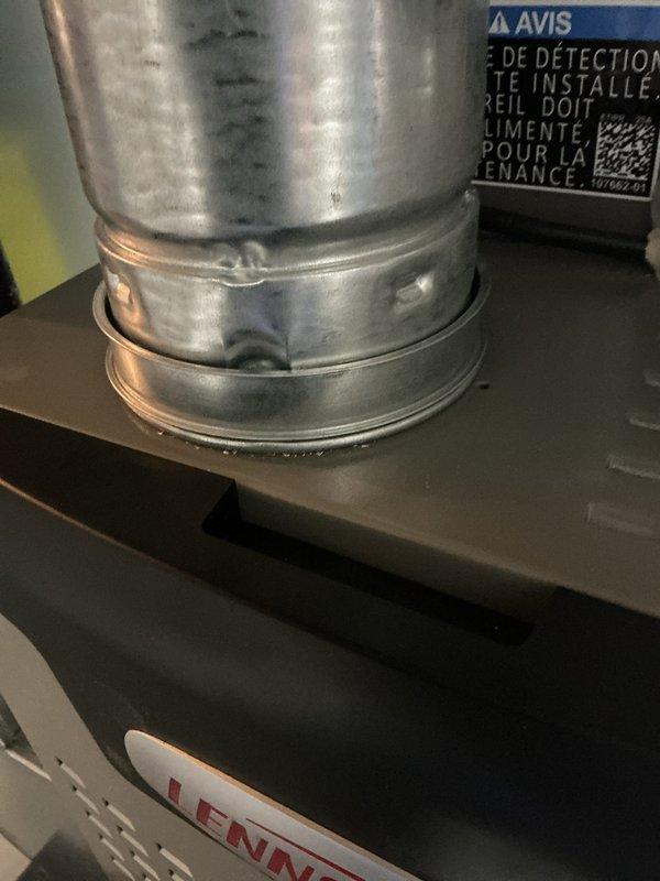 Completed installation callback to address three items identified post-installation: installed missing screw on air conditioning unit, secured loose metal ring clamp on furnace rubber boot connection, and tightened loose metal clamp on aluminum refrigerant line. All components verified secure and system operational per manufacturer specifications.
