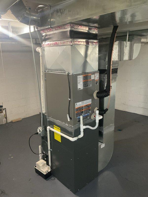 Completed installation of 2.5-ton air conditioning system with matching evaporator coil in basement utility area. Installed new condensing unit at rear of property, ran refrigerant lines to indoor coil mounted above existing furnace, and established new dedicated electrical circuit per code requirements. Verified proper airflow, refrigerant charge, and system operation upon startup, with all mechanical and electrical permits obtained and inspections completed.