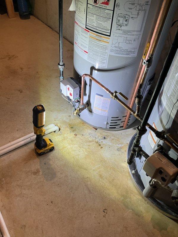 Completed warranty hot water tank replacement due to leaking from bottom of original unit. Installed new water heater with expansion tank as specified, utilizing proper copper piping connections and brass fittings with PTFE thread seal. All plumbing connections tested and verified leak-free upon completion.