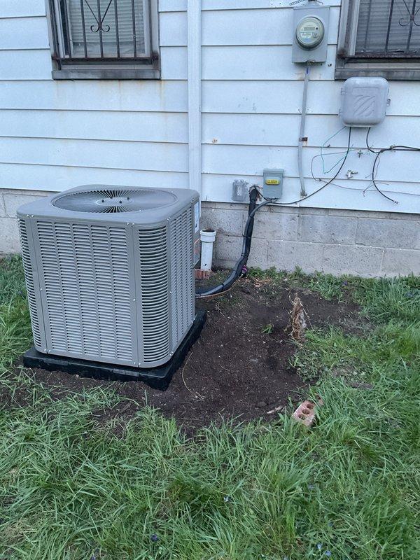 Completed full installation of 2-ton air conditioning system with evaporator coil at rear of residence. Installed new outdoor condenser unit on concrete pad with proper refrigerant line sets and electrical connections routed along exterior wall to main electrical panel. Mounted new evaporator coil on existing furnace in basement, established all necessary ductwork connections, and completed electrical wiring with proper disconnects. System was charged with refrigerant, tested for proper operation, and all mechanical, electrical, and air conditioning permits were obtained prior to installation.