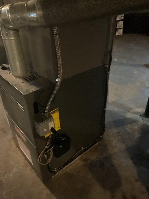 Completed full installation of 2-ton air conditioning system with evaporator coil at rear of residence. Installed new outdoor condenser unit on concrete pad with proper refrigerant line sets and electrical connections routed along exterior wall to main electrical panel. Mounted new evaporator coil on existing furnace in basement, established all necessary ductwork connections, and completed electrical wiring with proper disconnects. System was charged with refrigerant, tested for proper operation, and all mechanical, electrical, and air conditioning permits were obtained prior to installation.