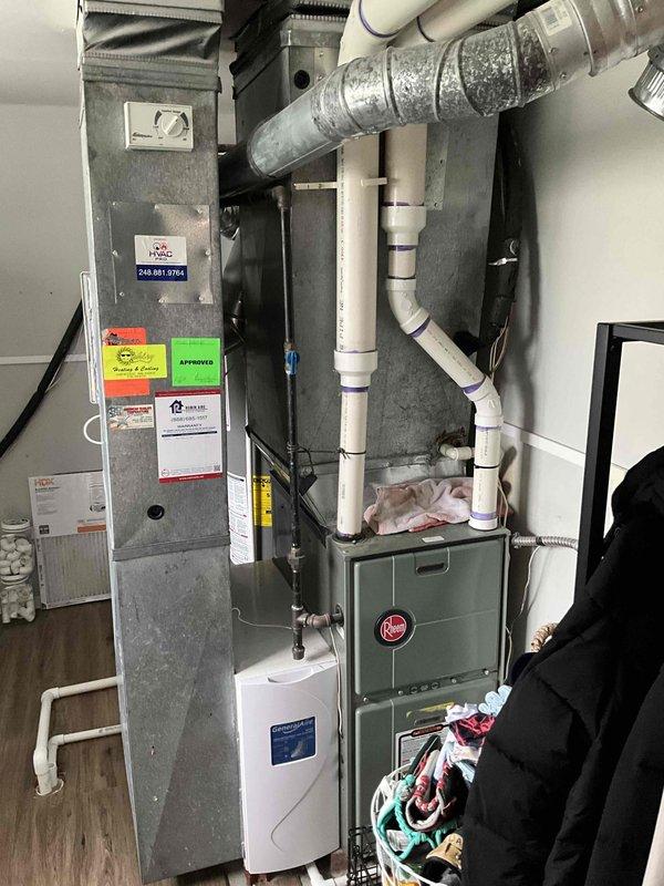 Conducted comprehensive on-site evaluation of 29-year-old Heil HVAC system for full replacement estimate. Assessed existing equipment configuration including air handler unit, furnace, and associated ductwork in residential utility closet installation. Documented current system condition showing significant age-related wear, dust accumulation, and outdated components. Photographed complete mechanical setup including vertical air handler with multiple service labels, green furnace unit with control interface, flexible metal ductwork, white PVC condensate drainage lines with visible primer markings, and corrugated refrigerant line connections. Evaluated spatial constraints and existing infrastructure for replacement planning. Provided detailed quote for complete HVAC system replacement to address outdated equipment and improve efficiency.