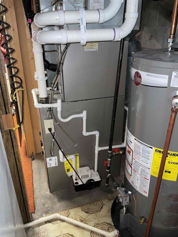 Completed HVAC estimate for indoor air quality equipment installation to existing residential furnace system in basement utility room. Assessed current setup including gray metal furnace with PVC venting system, Rheem water heater, and condensate pump on concrete floor. Evaluated mechanical room configuration with exposed framing and utility equipment layout to determine optimal placement and integration of proposed IAQ solutions with existing HVAC infrastructure.