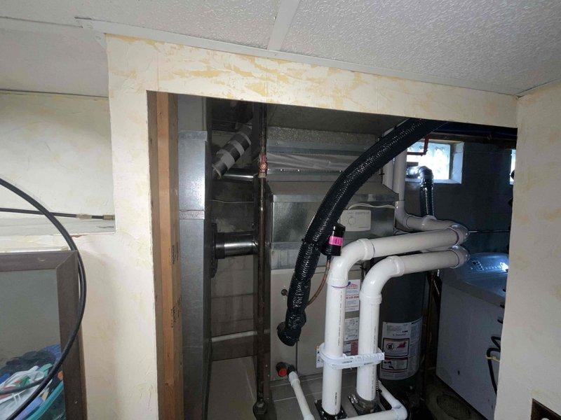 Completed HVAC estimate for indoor air quality equipment installation to existing residential furnace system in basement utility room. Assessed current setup including gray metal furnace with PVC venting system, Rheem water heater, and condensate pump on concrete floor. Evaluated mechanical room configuration with exposed framing and utility equipment layout to determine optimal placement and integration of proposed IAQ solutions with existing HVAC infrastructure.
