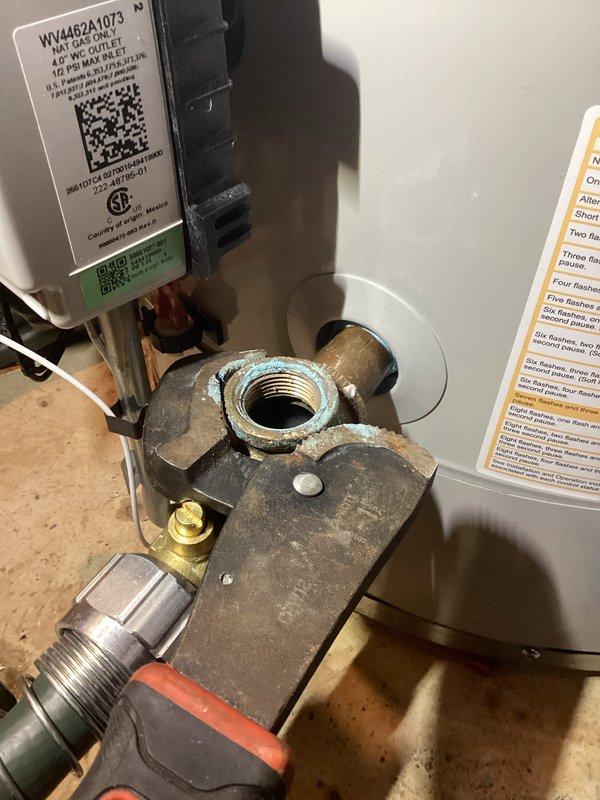 Responded to a water heater recirculation system leak at a threaded copper-to-brass fitting on the tie-in line. Drained the water heater tank completely, removed the defective soldered joint at the elbow connection, and re-soldered the fitting to establish a watertight seal. Service completed under full warranty coverage with no charge to the customer.