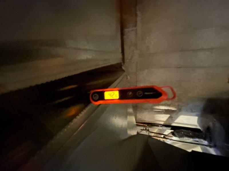 Responded to no airflow complaint on 3-year-old AC system. Upon arrival, confirmed outdoor unit running but no air delivery from supply registers. Performed diagnostic evaluation of indoor air handler and discovered evaporator coil completely frozen with heavy ice accumulation. Measured suction line temperature at outdoor unit showing 83°F, indicating restricted airflow across indoor coil. Shut system down to allow coil to thaw completely. Inspected air filter and found severely clogged condition restricting airflow. Replaced dirty filter with new filter. After thaw cycle completed, verified evaporator coil clear of ice and resumed system operation. Monitored system performance and confirmed proper airflow restored to all vents, suction line temperatures returning to normal range, and adequate cooling capacity. Advised customer on importance of regular filter maintenance to prevent future freezing issues.